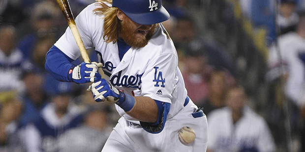 Los Angeles Dodgers' Justin Turner is hit by an Arizona Diamondbacks pitch during the fifth inning ...
