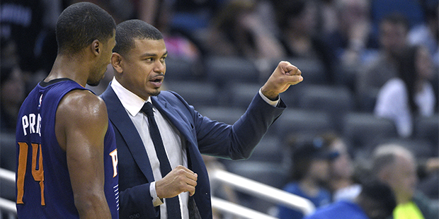 Phoenix Suns head coach Earl Watson, left, talks with guard Ronnie Price (14) on the sideline durin...