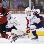 Arizona Coyotes' Anthony Duclair (10) sends a shot at Washington Capitals' Philipp Grubauer, of Germany, as Capitals' Dmitry Orlov, right, of Russia, defends during the first period of an NHL hockey game Saturday, April 2, 2016, in Glendale, Ariz. (AP Photo/Ross D. Franklin)