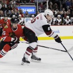 Chicago Blackhawks center Artem Anisimov (15) defends Arizona Coyotes defenseman Connor Murphy (5) in the first period of an NHL hockey game Tuesday, April 5, 2016, in Chicago. (AP Photo/David Banks)
