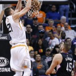 Phoenix Suns' Alex Len (21) dunks as Los Angeles Clippers' Cole Aldrich (45) watches during the first half of an NBA basketball game Wednesday, April 13, 2016, in Phoenix. (AP Photo/Ross D. Franklin)