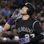 Colorado Rockies' Trevor Story looks to the sky as he arrives at home plate after hitting a home run against the Arizona Diamondbacks during the fourth inning of a baseball game Tuesday, April 5, 2016, in Phoenix. (AP Photo/Ross D. Franklin)
