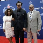 Mississippi's Robert Nkemdiche, center, poses for photos upon arriving for the first round of the 2016 NFL football draft at the Auditorium Theater of Roosevelt University, Thursday, April 28, 2016, in Chicago. (AP Photo/Nam Y. Huh)