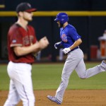 Chicago Cubs Jake Arrieta, right, rounds the bases after hitting a two run home run as Arizona Diamondbacks pitcher Shelby Miller, left, walks to the mound during the second inning of a baseball game, Sunday, April 10, 2016, in Phoenix. (AP Photo/Matt York)