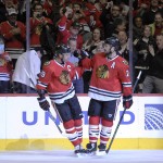 Chicago Blackhawks center Jonathan Toews (19) celebrates his goal against the Arizona Coyotes with Chicago Blackhawks defenseman Brent Seabrook (7) in the first period of an NHL hockey game Tuesday, April 5, 2016, in Chicago. (AP Photo/David Banks)