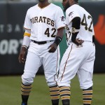 Pittsburgh Pirates' Andrew McCutchen, right, and Josh Harrison warm up while wearing No. 42 in honor of Jackie Robinson Day before a baseball game against the Milwaukee Brewers in Pittsburgh, Friday, April 15, 2016. (AP Photo/Gene J. Puskar)