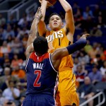 Phoenix Suns guard Devin Booker (1) shoots over Washington Wizards guard John Wall (2) during the second half of an NBA basketball game, Friday, April 1, 2016, in Phoenix. (AP Photo/Matt York)