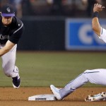 Arizona Diamondbacks' David Peralta (6) is forced out at second base by Colorado Rockies' DJ LeMahieu, left, during the first inning of a baseball game Tuesday, April 5, 2016, in Phoenix. (AP Photo/Ross D. Franklin)
