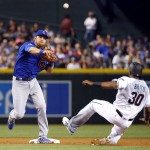 Chicago Cubs Ben Zobrist forces out Arizona Diamondbacks Socrates Brito (30) as he turns a double play on David Peralta during the first inning of a baseball game, Friday, April 8, 2016, in Phoenix. (AP Photo/Matt York)