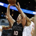 Phoenix Suns forward Chase Budinger (10) shoots against Atlanta Hawks center Al Horford (15) during the first half of an NBA game Tuesday, April 5, 2016, in Atlanta. (AP Photo/John Bazemore)