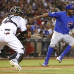 Chicago Cubs Dexter Fowler gets caught in a double play as Arizona Diamondbacks catcher Welington Castillo (7) makes the catch during the fifth inning of a baseball game, Friday, April 8, 2016, in Phoenix. (AP Photo/Matt York)