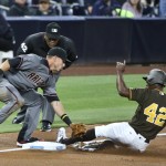 San Diego Padres' Melvin Upton Jr. s;ides under the tag of Arizona Diamondbacks third baseman Jake Lamb while stealing a base during the second inning of a baseball game Friday, April 15, 2016, in San Diego. The umpire is Laz Diaz. (AP Photo/Lenny Ignelzi)