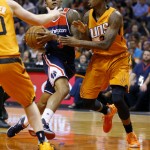 Washington Wizards guard Bradley Beal drives as Phoenix Suns guard Archie Goodwin, right, defends during the first half of an NBA basketball game Friday, April 1, 2016, in Phoenix. (AP Photo/Matt York)