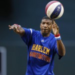 Harlem Globetrotters' Buckets Blakes throws out the first pitch as he spins a basketball with his other hand prior to a baseball game between the Arizona Diamondbacks and the St. Louis Cardinals Wednesday, April 27, 2016, in Phoenix. (AP Photo/Ross D. Franklin)
