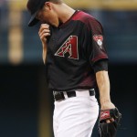 Arizona Diamondbacks' Zack Greinke pauses on the mound during the first inning of a baseball game against the Chicago Cubs on Saturday, April 9, 2016, in Phoenix. (AP Photo/Ross D. Franklin)