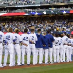 Members of the Los Angeles Dodgers line up for the national anthem as they wear No. 2 in honor of former Dodger Jackie Robinson prior to a baseball game against the San Francisco Giants, Friday, April 15, 2016, in Los Angeles. (AP Photo/Mark J. Terrill)