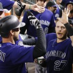 Colorado Rockies' Ryan Raburn, front left, celebrates his home run against the Arizona Diamondbacks with Trevor Story (27) and manager Walt Weiss, left, during the fourth inning of a baseball game Friday, April 29, 2016, in Phoenix. (AP Photo/Ross D. Franklin)