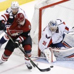 Arizona Coyotes' Jordan Martinook (48) gets his shot blocked by Washington Capitals' Philipp Grubauer (31), of Germany, as Capitals' Karl Alzner (27) defends during the second period of an NHL hockey game Saturday, April 2, 2016, in Glendale, Ariz. (AP Photo/Ross D. Franklin)