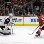 Chicago Blackhawks center Jonathan Toews (19) skates in to shoot on Arizona Coyotes goalie Louis Domingue (35) in the first period of an NHL hockey game Tuesday, April 5, 2016, in Chicago. (AP Photo/David Banks)