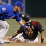 Chicago Cubs' Ben Zobrist, left, applies a late tag as Arizona Diamondbacks' David Peralta, right, steals second base during the seventh inning of a baseball game Saturday, April 9, 2016, in Phoenix. The Cubs defeated the Diamondbacks 4-2. (AP Photo/Ross D. Franklin)