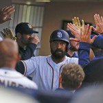 San Diego Padres' Matt Kemp high fives his way through the dugout after hitting a solo home run against the Arizona Diamondbacks in the third inning of a baseball game Saturday, April 16, 2016, in San Diego. (AP Photo/Lenny Ignelzi)