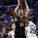 Phoenix Suns forward Mirza Teletovic (35) goes to the basket between New Orleans Pelicans guard Jordan Hamilton (25) and forward Luke Babbitt (8) in the second half of an NBA basketball game in New Orleans, Saturday, April 9, 2016. (AP Photo/Gerald Herbert)