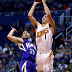 Phoenix Suns guard Devin Booker (1) shoots over Sacramento Kings guard Seth Curry (30) during the second half of an NBA basketball game, Monday, April 11, 2016, in Phoenix. (AP Photo/Matt York)