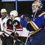 Arizona Coyotes' Anthony Duclair, left, celebrates with Alex Tanguay after scoring a goal against St. Louis Blues goalie Brian Elliott during the first period of an NHL hockey game Monday, April 4, 2016, in St. Louis. (AP Photo/Billy Hurst)