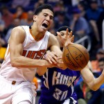 Phoenix Suns guard Devin Booker (1) has the ball knocked away by Sacramento Kings guard Seth Curry (30) during the second half of an NBA basketball game, Monday, April 11, 2016, in Phoenix. (AP Photo/Matt York)