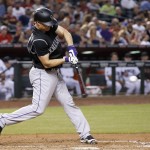 Colorado Rockies' Nick Hundley connects for a three-run home run against the Arizona Diamondbacks during the fourth inning of a baseball game Tuesday, April 5, 2016, in Phoenix. (AP Photo/Ross D. Franklin)