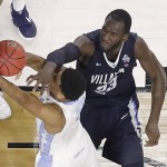 North Carolina forward Isaiah Hicks (4) and Villanova forward Daniel Ochefu (23) collide under the hoop during the second half of the NCAA Final Four tournament college basketball championship game Monday, April 4, 2016, in Houston. (AP Photo/Michael Simmons)