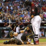 Pittsburgh Pirates catcher Francisco Cervelli, bottom, grabs his leg after being hit by a foul tip by Arizona Diamondbacks' Jean Segura, right, during the fifth inning of a baseball game, Saturday, April 23, 2016, in Phoenix. (AP Photo/Matt York)