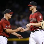 Arizona Diamondbacks pitcher Shelby Miller, right, is removed from the game by manager Chip Hale after giving up a solo home run against the Chicago Cubs during the sixth inning of a baseball game, Sunday, April 10, 2016, in Phoenix. (AP Photo/Matt York)