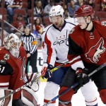 Arizona Coyotes' Mike Smith (41) makes a save off his shoulder as Coyotes' Connor Murphy (5) and Washington Capitals' Justin Williams (14) work for position during the first period of an NHL hockey game Saturday, April 2, 2016, in Glendale, Ariz. (AP Photo/Ross D. Franklin)