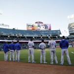 Kansas City Royals wear Jackie Robinson's number as they listen to the national anthem before a baseball game against the Oakland Athletics on Friday, April 15, 2016, in Oakland, Calif. (AP Photo/Marcio Jose Sanchez)