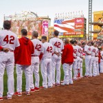 Members of the St. Louis Cardinals wear uniforms with the No. 42 to honor Jackie Robinson before a baseball game against the Cincinnati Reds, Friday, April 15, 2016, in St. Louis. (AP Photo/Tom Gannam)