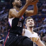 Los Angeles Clippers' C.J. Wilcox (30) drives past Phoenix Suns' Mirza Teletovic (35) for a score during the first half of an NBA basketball game Wednesday, April 13, 2016, in Phoenix. (AP Photo/Ross D. Franklin)