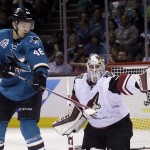 Arizona Coyotes goalie Mike Smith, right, deflects a shot in front of San Jose Sharks' Tomas Hertl (48) during the first period of an NHL hockey game Saturday, April 9, 2016, in San Jose, Calif. (AP Photo/Marcio Jose Sanchez)