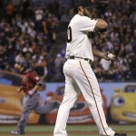 San Francisco Giants pitcher Madison Bumgarner, foreground, reacts after Arizona Diamondbacks' Welington Castillo, rear, hit a two-run home run during the seventh inning of a baseball game in San Francisco, Wednesday, April 20, 2016. (AP Photo/Jeff Chiu)