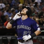 Colorado Rockies' Trevor Story points skyward as he arrives at home plate after hitting a home run against the Arizona Diamondbacks during the fifth inning of a baseball game Friday, April 29, 2016, in Phoenix. (AP Photo/Ross D. Franklin)