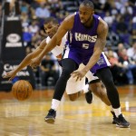 Sacramento Kings guard James Anderson (5) has the ball knocked loose by Phoenix Suns guard Ronnie Price (14) during the first half of an NBA basketball game, Monday, April 11, 2016, in Phoenix. (AP Photo/Matt York)