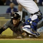 Arizona Diamondbacks' Chris Herrmann scores past Los Angeles Dodgers catcher A.J. Ellis on a hit by Nick Ahmed during fifth inning of a baseball game in Los Angeles, Thursday, April 14, 2016. (AP Photo/Chris Carlson)
