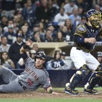 Arizona Diamondbacks' Jake Lamb tags home plate scoring on a squeeze play in the ninth inning as San Diego Padres catcher Derek Norris takes in the late throw in the ninth inning of a baseball game won by Arizona 3-2 Friday, April 15, 2016, in San Diego. (AP Photo/Lenny Ignelzi)