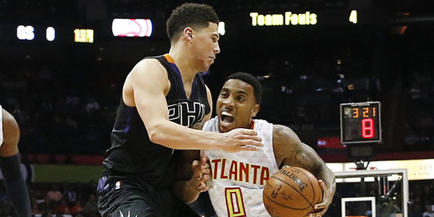 Atlanta Hawks guard Jeff Teague (0) drives against Phoenix Suns guard Devin Booker during the secon...