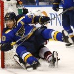 St. Louis Blues' Alexander Steen, front, falls into the net as he is tangled up with Arizona Coyotes' Zbynek Michalek, of the Czech Republic, during the second period of an NHL hockey game Monday, April 4, 2016, in St. Louis. (AP Photo/Billy Hurst)