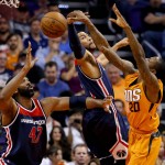 Phoenix Suns guard Archie Goodwin (20) loses the ball as Washington Wizards center Nene (42) and guard Garrett Temple defend during the first half of an NBA basketball game, Friday, April 1, 2016, in Phoenix. (AP Photo/Matt York)