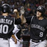 Colorado Rockies' DJ LeMahieu (9) celebrates his two-run home run against the Arizona Diamondbacks with Ben Paulsen (10) during the fourth inning of a baseball game Tuesday, April 5, 2016, in Phoenix. (AP Photo/Ross D. Franklin)