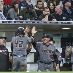 Arizona Diamondbacks' Jake Lamb is congratulated at the dugout after scoring on a squeeze play in the ninth inning that gave the Diamondbacks a 3-2 victory over the San Diego Padres in a baseball game Friday, April 15, 2016, in San Diego. (AP Photo/Lenny Ignelzi)