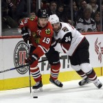 Chicago Blackhawks center Jonathan Toews (19) is defended by Arizona Coyotes defenseman Klas Dahlbeck (34) in the first period of an NHL hockey game Tuesday, April 5, 2016, in Chicago. (AP Photo/David Banks)
