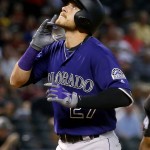 Colorado Rockies Trevor Story (27) points upward after hitting a two RBI home run against the Arizona Diamondbacks during the first inning of a baseball game, Wednesday, April 6, 2016, in Phoenix. (AP Photo/Matt York)